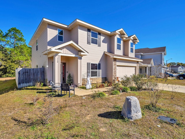 view of front of property with a garage and a front lawn