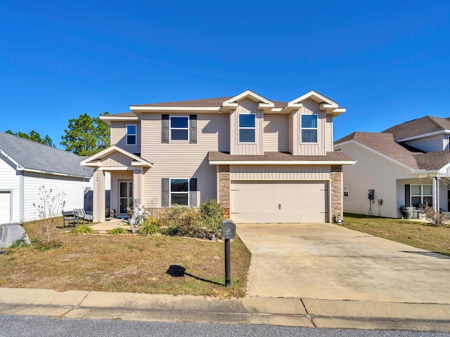 view of front of home with a front yard and a garage