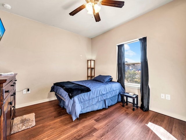 bedroom featuring ceiling fan and dark wood-type flooring