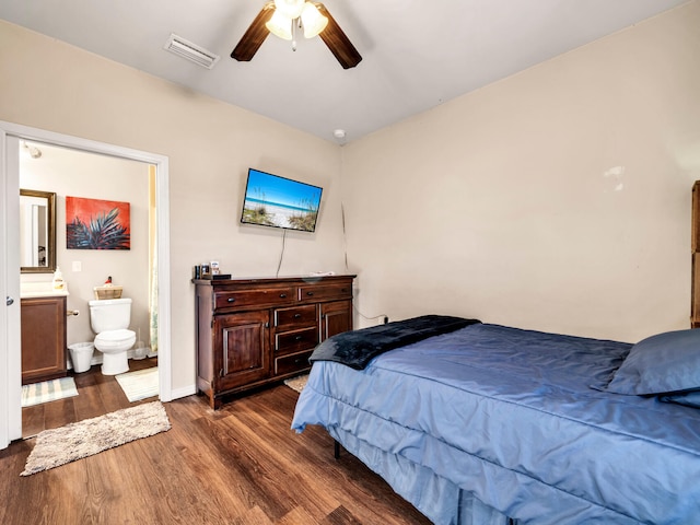 bedroom featuring ensuite bathroom, ceiling fan, and dark wood-type flooring