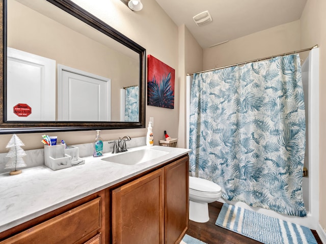 bathroom with hardwood / wood-style floors, vanity, and toilet