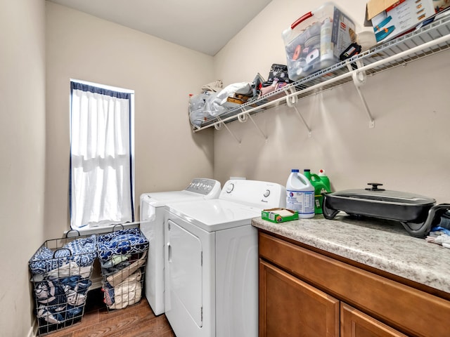 clothes washing area featuring washing machine and clothes dryer and dark wood-type flooring