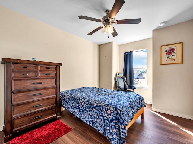 bedroom featuring ceiling fan and dark wood-type flooring