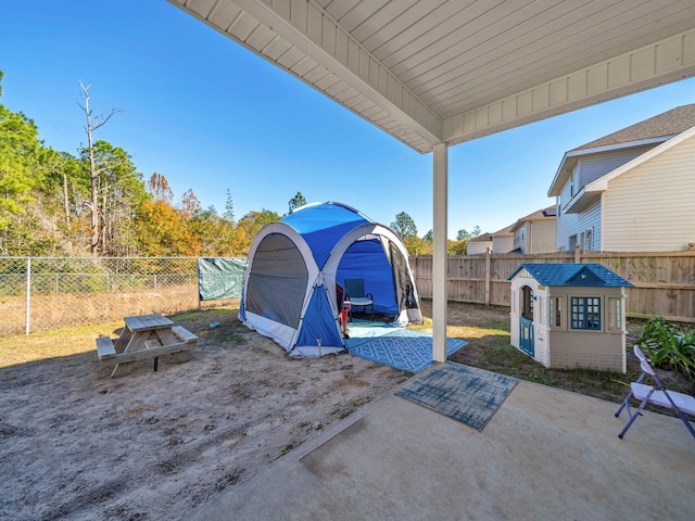 view of patio with a storage shed