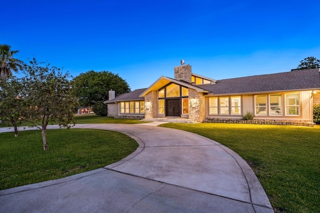 ranch-style home with a front lawn