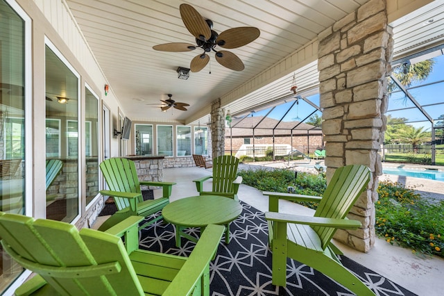 view of patio / terrace with a lanai and ceiling fan