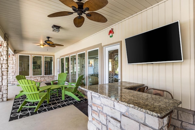 view of patio / terrace featuring ceiling fan and an outdoor bar