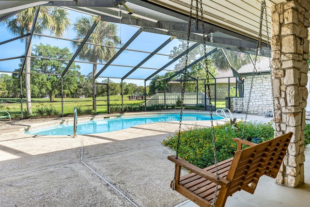 view of swimming pool featuring a lanai and a patio