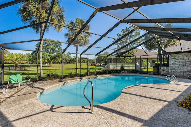 view of swimming pool with a lanai, a lawn, and a patio area