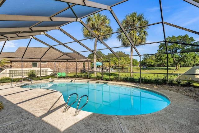 view of swimming pool featuring a lanai and a patio area