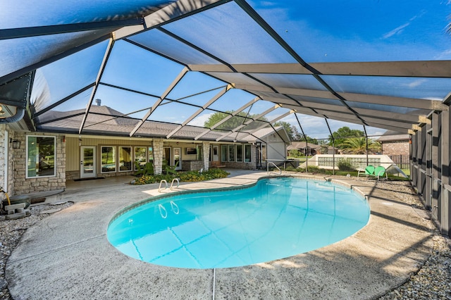 view of swimming pool with a patio area and glass enclosure