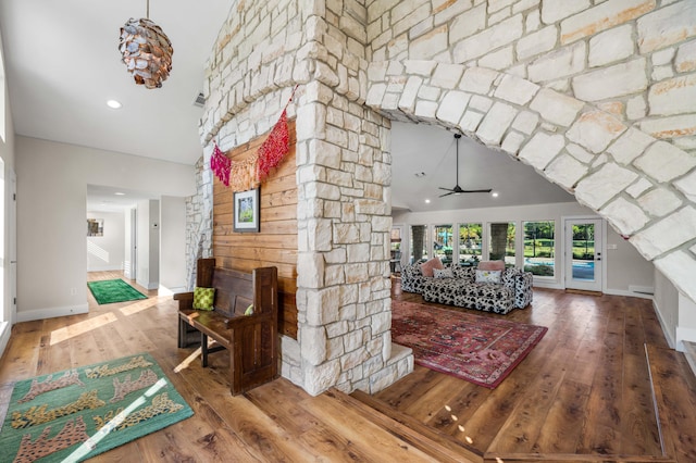 interior space with ceiling fan, wood-type flooring, and high vaulted ceiling