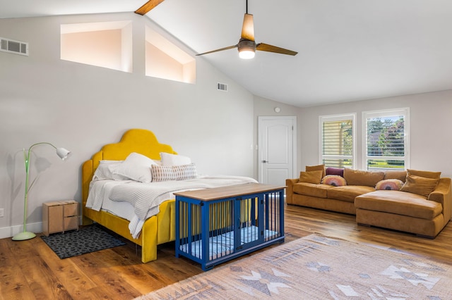 bedroom with ceiling fan, wood-type flooring, and vaulted ceiling