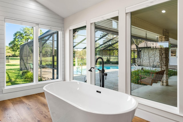 interior space featuring vaulted ceiling, plenty of natural light, light hardwood / wood-style flooring, and sink