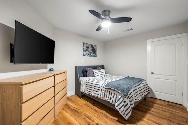 bedroom with ceiling fan and light hardwood / wood-style flooring