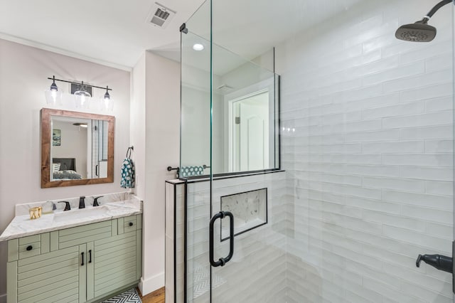 bathroom featuring vanity and a shower with door