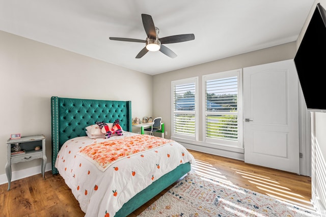 bedroom with ceiling fan and dark hardwood / wood-style floors