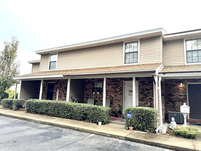 view of front facade featuring central AC unit and a porch