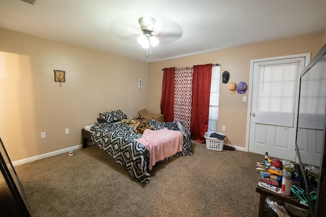 bedroom with ceiling fan, carpet floors, and a textured ceiling