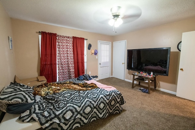 bedroom featuring carpet, a textured ceiling, and ceiling fan