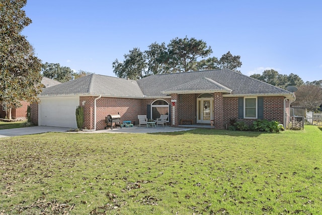 single story home featuring a front lawn, a patio, and a garage