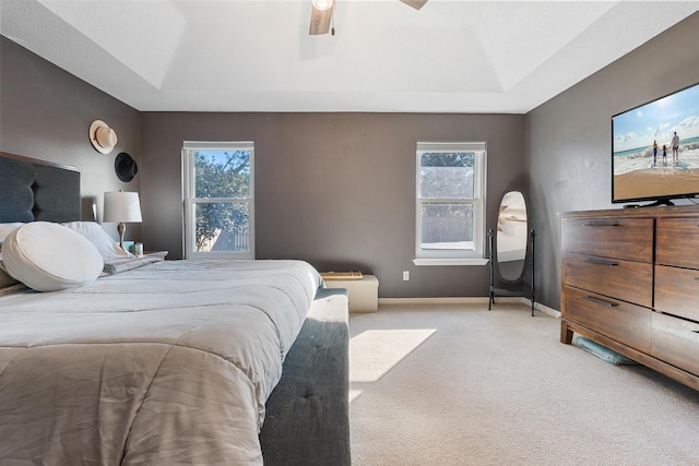 carpeted bedroom featuring multiple windows and ceiling fan