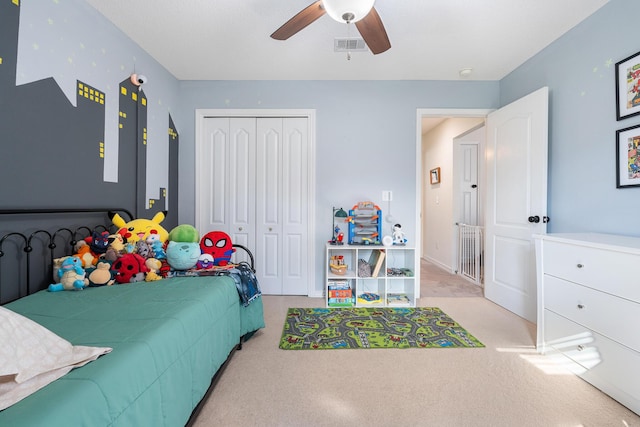 bedroom with ceiling fan, a closet, and light carpet