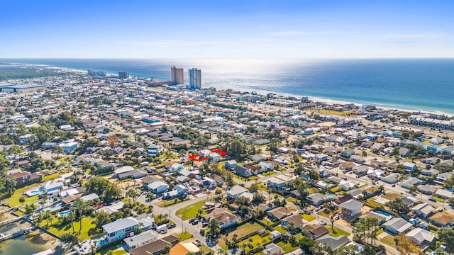 drone / aerial view featuring a water view and a beach view