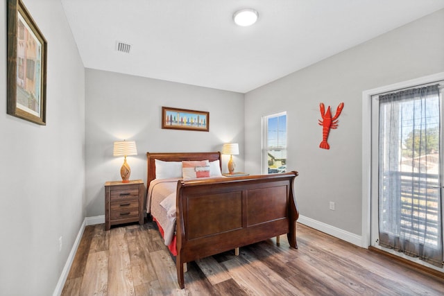 bedroom featuring access to outside and hardwood / wood-style flooring