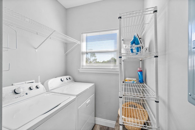 clothes washing area with hardwood / wood-style floors and separate washer and dryer