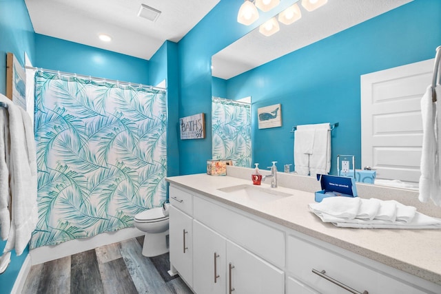 bathroom featuring a shower with curtain, vanity, toilet, and wood-type flooring