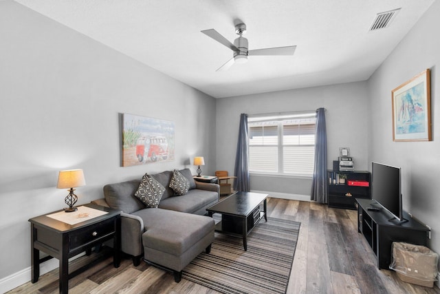 living room with wood-type flooring and ceiling fan