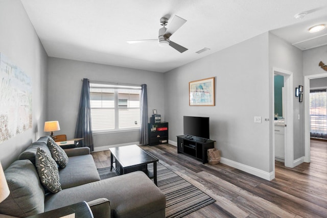 living room with dark hardwood / wood-style floors, a wealth of natural light, and ceiling fan