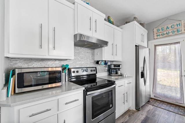 kitchen featuring white cabinets, backsplash, dark hardwood / wood-style flooring, and stainless steel appliances