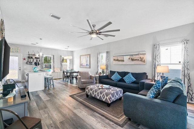 living room featuring ceiling fan and wood-type flooring