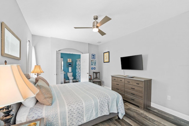 bedroom featuring dark hardwood / wood-style flooring, ensuite bathroom, and ceiling fan