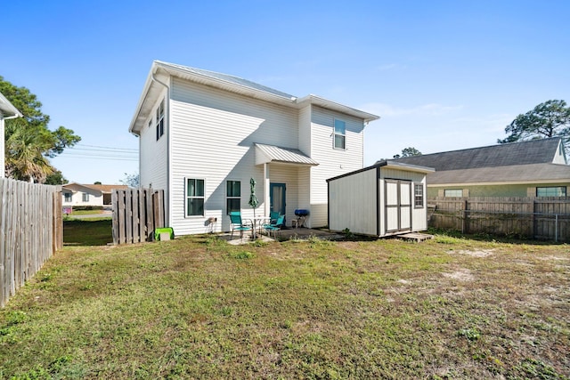 back of property with a patio area, a yard, and a storage shed