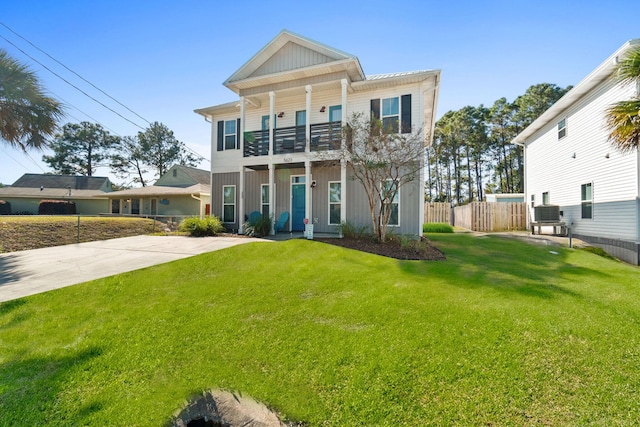 view of front of house with a front yard and a balcony