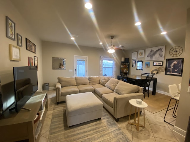 living room with light tile patterned floors and ceiling fan