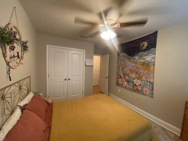 bedroom with ceiling fan and a closet