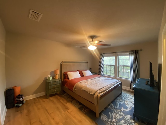 bedroom with ceiling fan and light hardwood / wood-style flooring