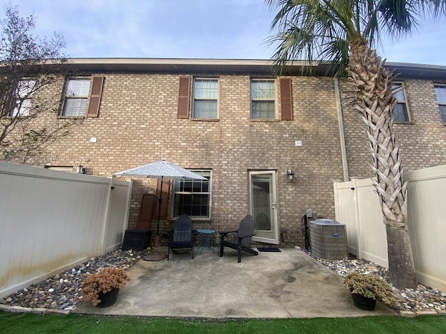 back of property featuring cooling unit and a patio