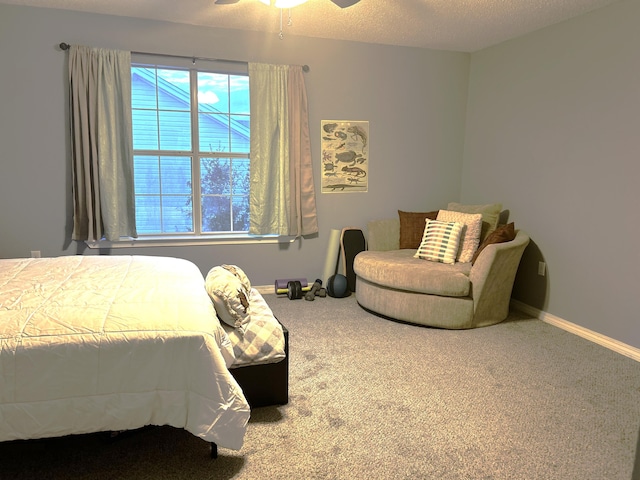 carpeted bedroom featuring a textured ceiling and ceiling fan