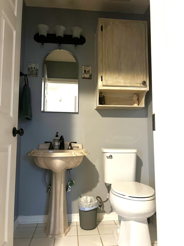 bathroom featuring tile patterned flooring and toilet