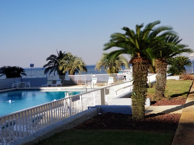 view of pool featuring a water view