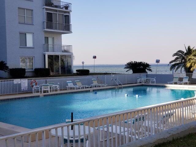 view of pool at dusk