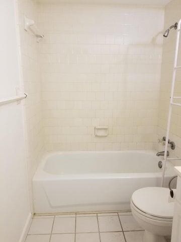 full bathroom with tile patterned floors, vanity, tiled shower / bath combo, and toilet