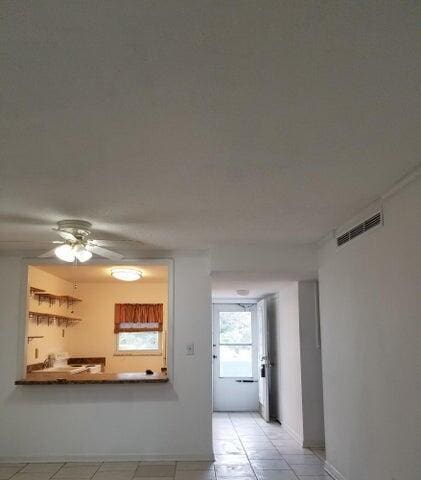 kitchen with light tile patterned floors and ceiling fan