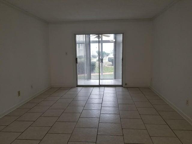 empty room featuring ceiling fan and light tile patterned floors