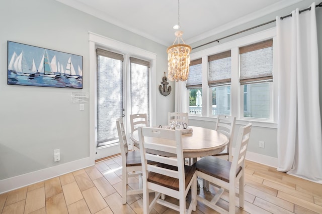 dining room with a chandelier and ornamental molding